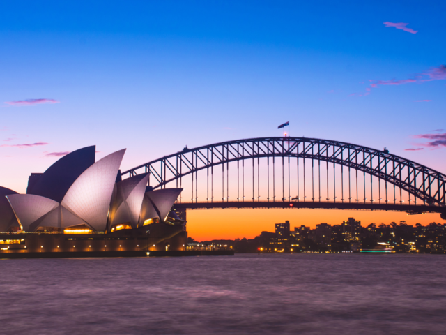 A Photo of Sydney, Australia showing the Sydney Harbour Bridge over water and the Sydney Opera House