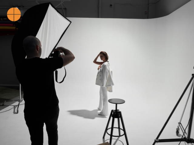 A photographer and model during a photoshot, fashion photography.